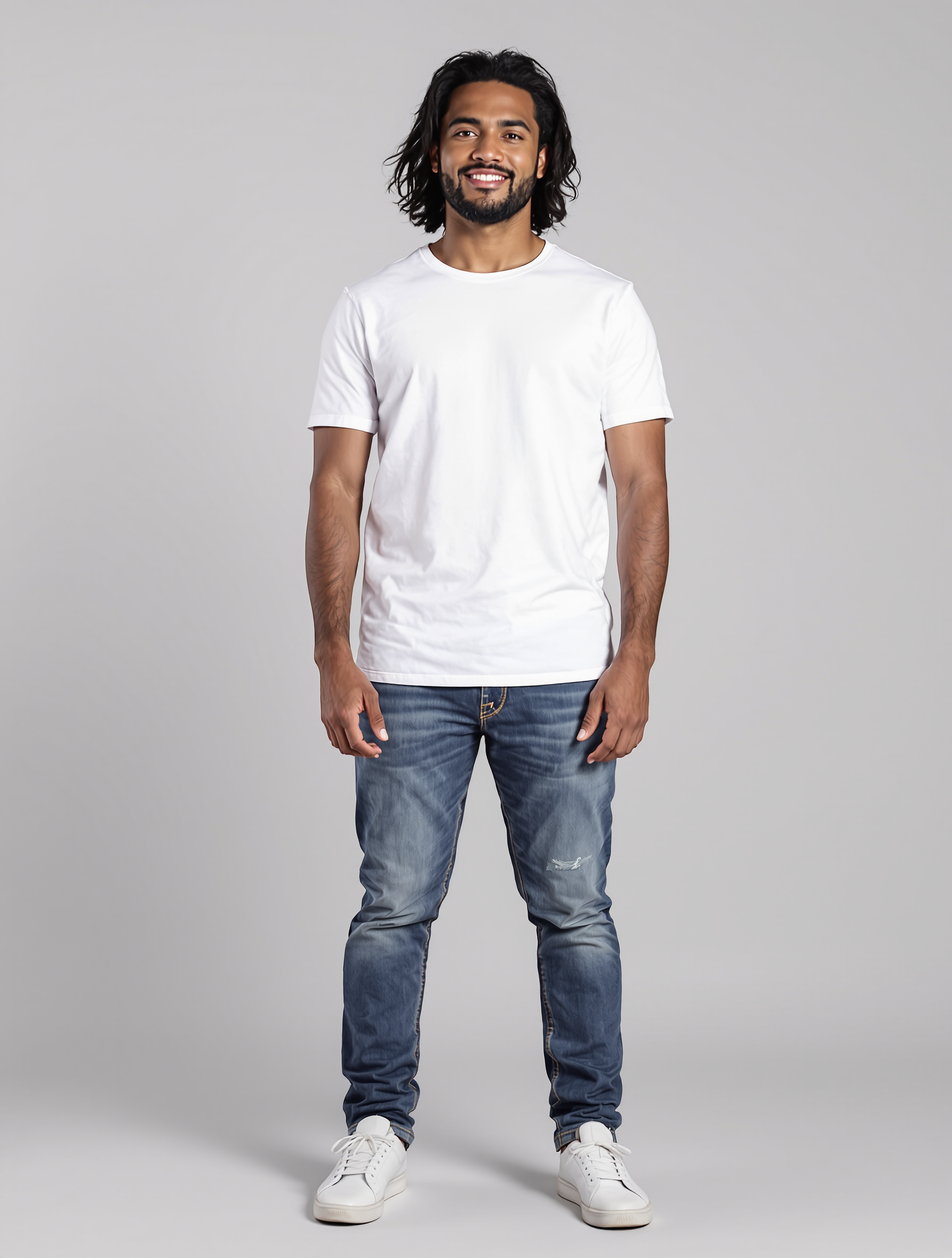 Man in white t-shirt and distressed blue jeans with white sneakers