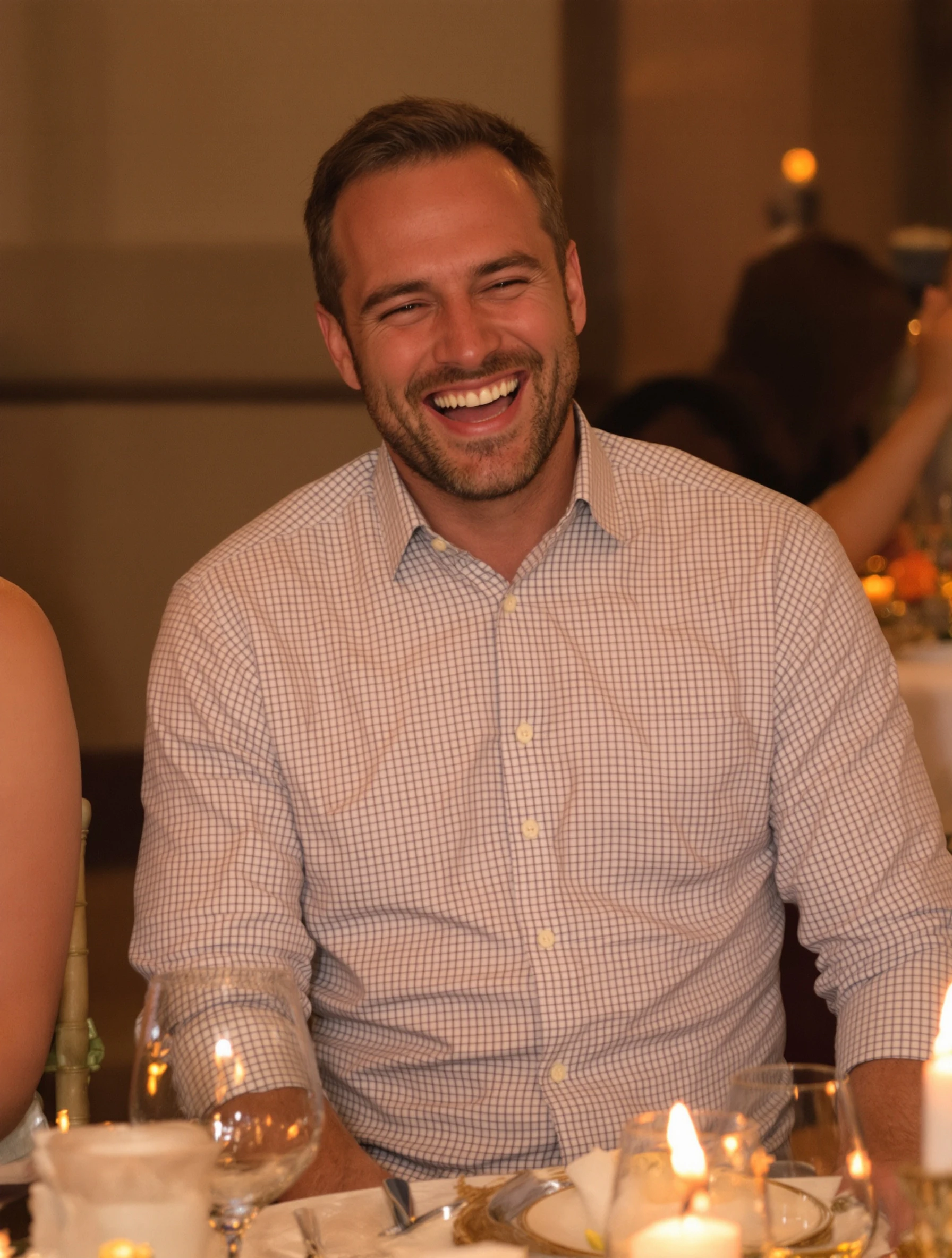 Man genuinely laughing at a dinner party with friends, candlelit table setting with wine glasses. Casual button-down shi