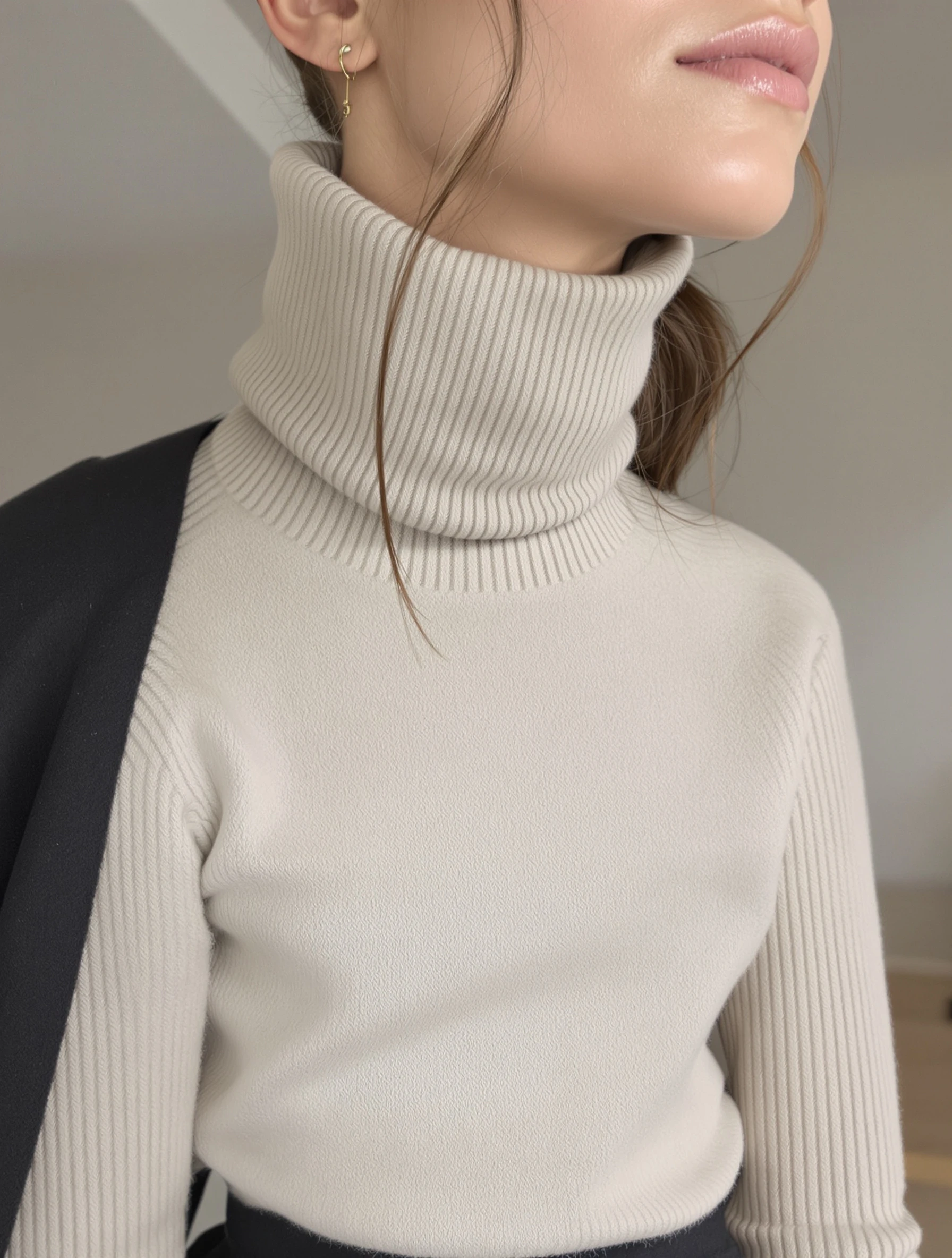 Woman in cashmere turtleneck, luxurious minimalist essential. Quality fabric, simple silhouette, sophisticated comfort, winter elegance.