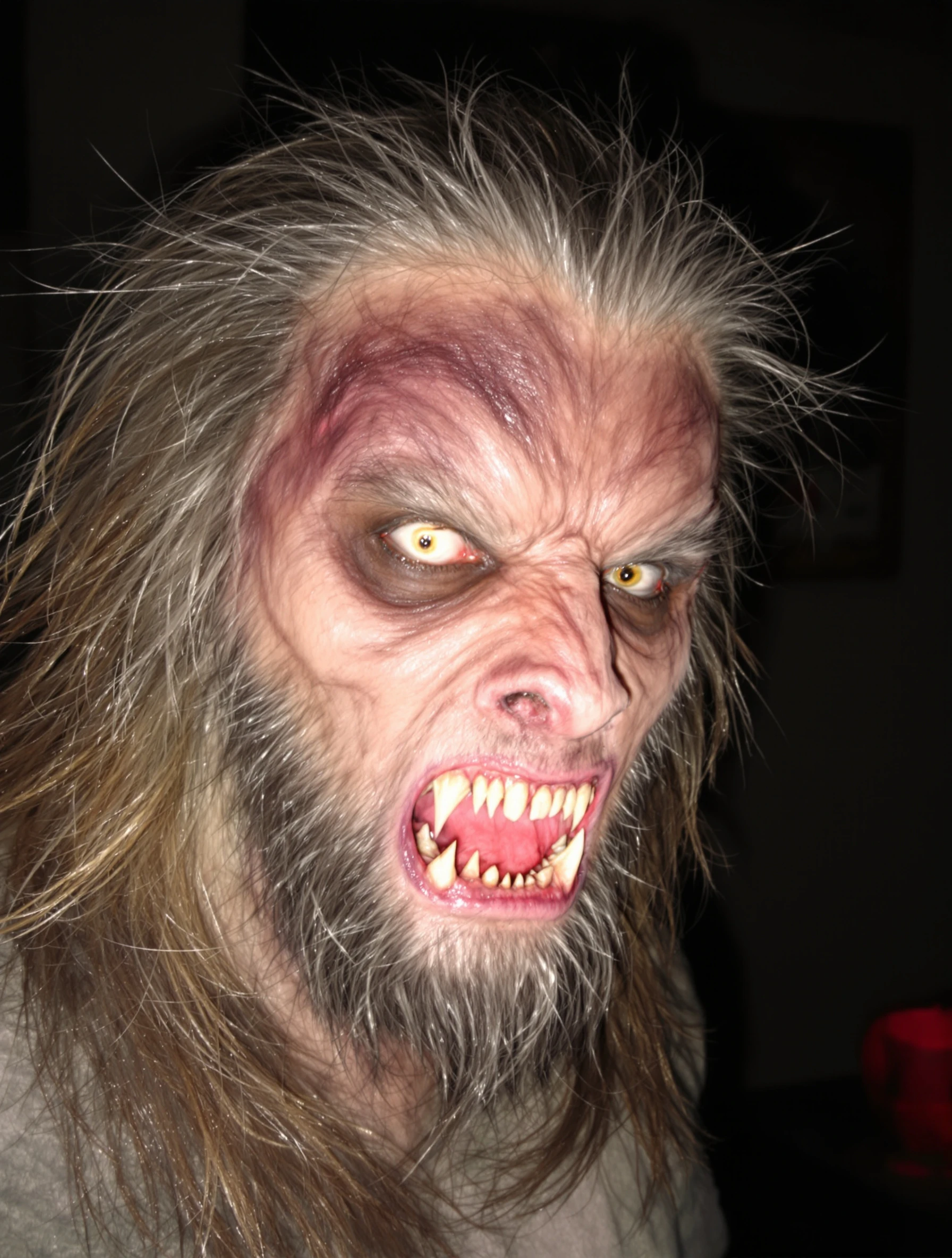 Man in terrifying werewolf costume, impressive transformation. Monster makeup, hairy and scary, full moon ready, Halloween creature.