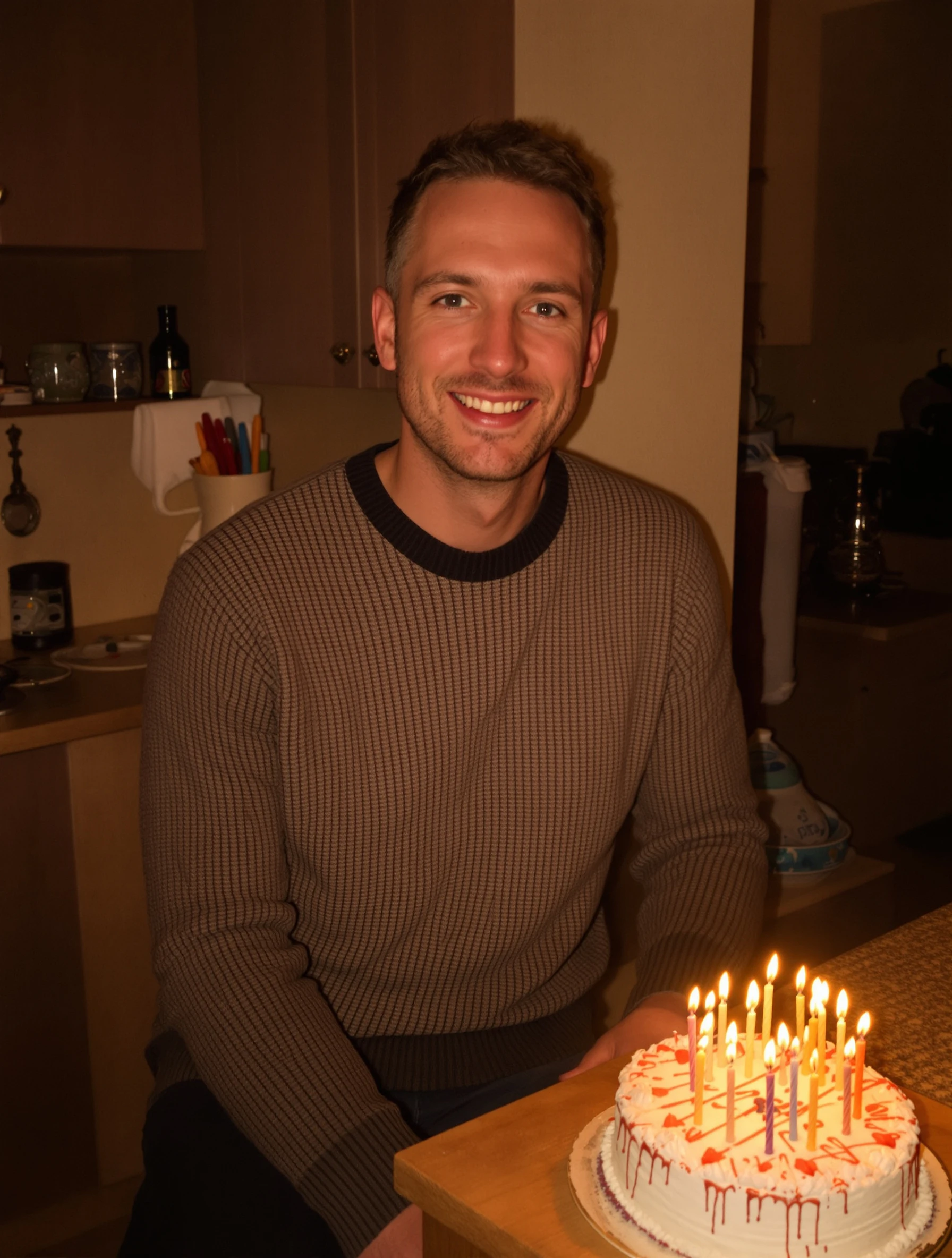 Man in a knit sweater sitting at a kitchen counter with a homemade cake covered in candles, cozy warm light, looking at the camera with a soft smile.