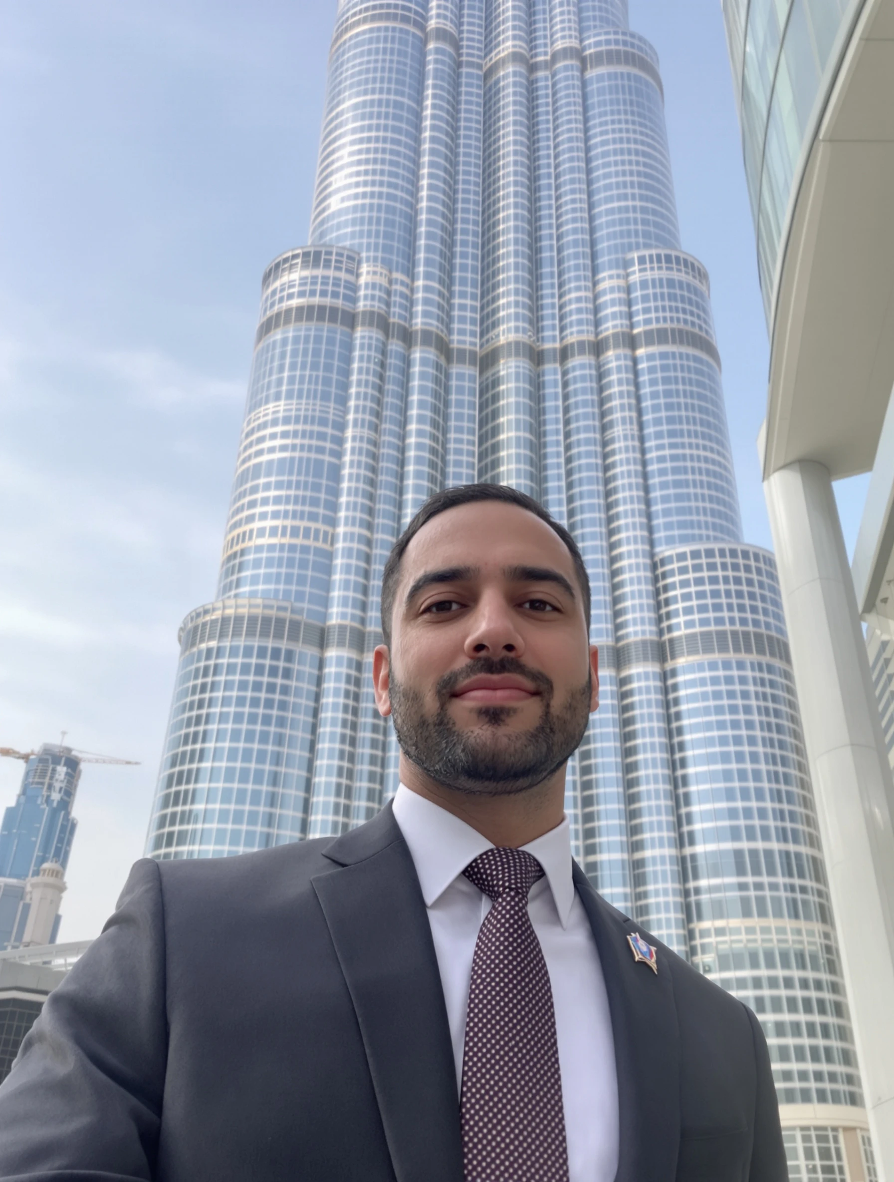 Man in business suit with Burj Khalifa behind, success and ambition. Sharp tailoring, futuristic towers, Dubai business energy, global commerce.